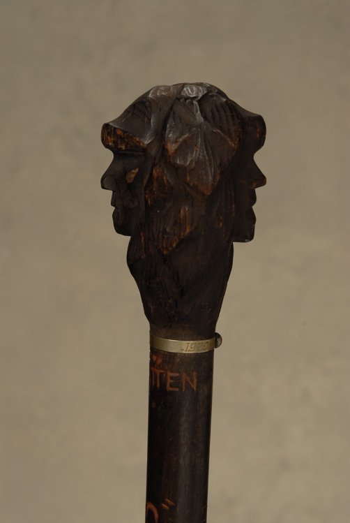 A very good New Hampshire College cane: A very good New Hampshire College cane of the Old Man in the Mountain. The dark stained hardwood handle is 3 1/4” high and 2 1/2” at its widest. It depicts the double profile of the Old Man in the