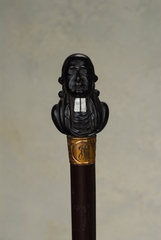 A very nice cane with a bust of John Wesley: A very nice cane with a bust of John Wesley, founder of Methodism. The ebony handle is 2 1/4" high and 1 1/2" at its widest. It depicts in fine detail, John Wesley, English theologian educated at Chri