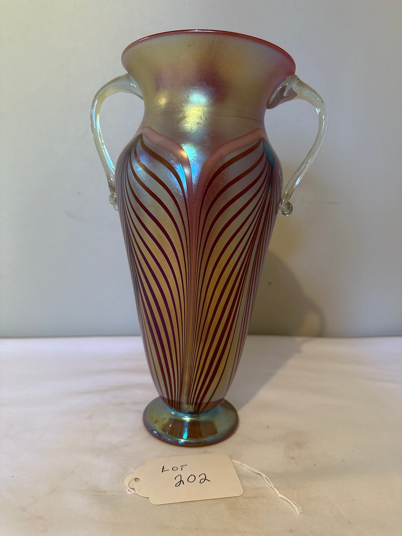 Iridescent Art Glass Vase: Exquisite iridescent art glass vase with flowing patterns and glass handles, perfect for enhancing any space with its artisanal elegance. Ideal for collectors and decorators seeking unique pieces.Mate