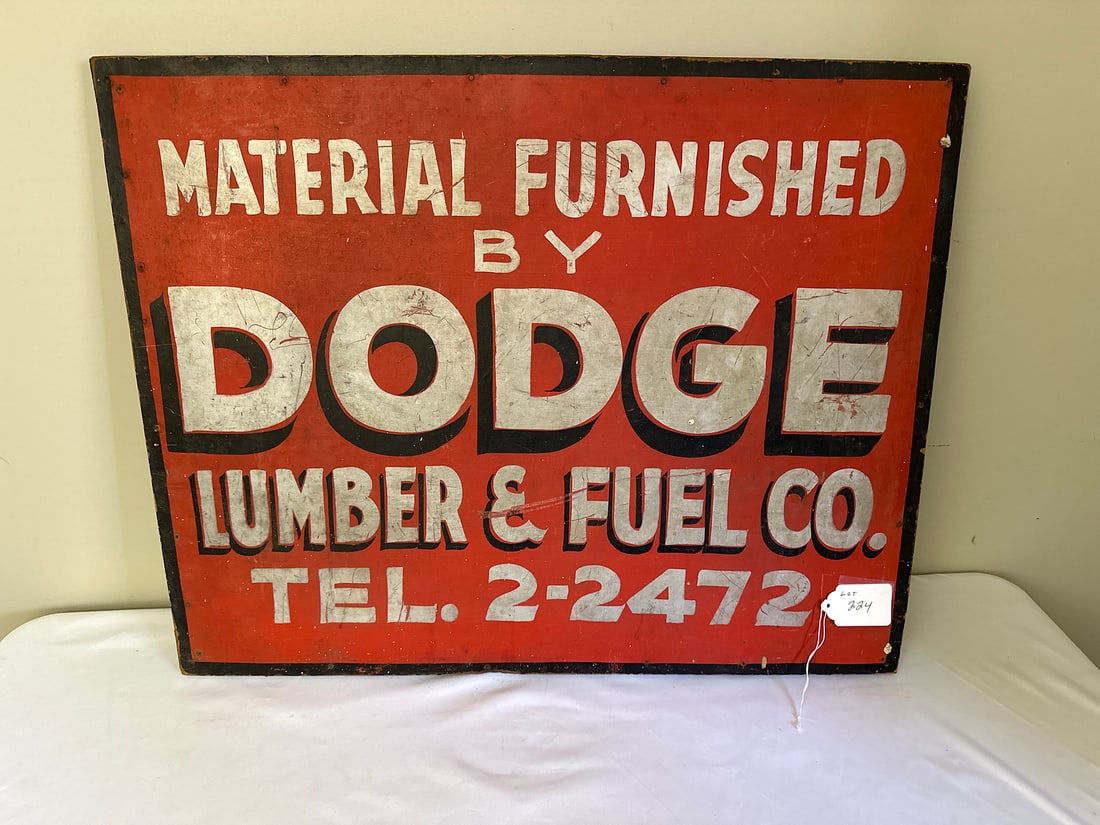 Dodge Lumber Co. Vintage Wood Advertising Sign: Vintage advertising sign from Dodge Lumber & Fuel Co., offering a glimpse into historic business promotion. Perfect for collectors or enthusiasts seeking unique Americana pieces. The aged patina contr