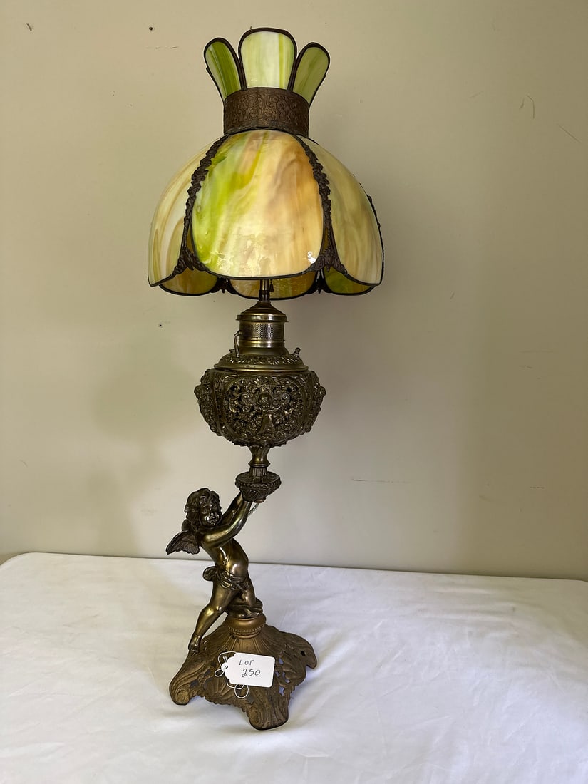 Antique Cherub Stained Glass Lamp: An exquisite antique table lamp featuring a cherub figure as its base, topped with a colorful stained glass shade. Ideal for vintage decor enthusiasts, this piece combines artistry and functionality w