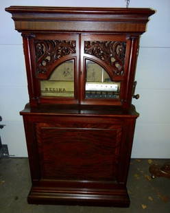 Regina Upright 27" Automatic Changer Music Box: Has 15 Discs- Mahogany Griffin Doored Cabinet- Nice Old Finish- Very Good Sounding Condition- 38" Wide X 66" Tall X 24" Deep- Been in on Family for 50 Years- Plays Beautifully