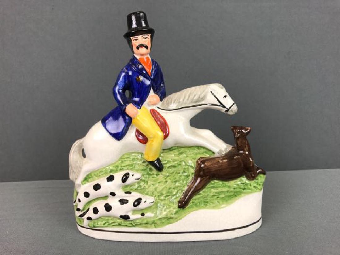 Staffordshire Figure: 8" x 7" Staffordshire figure, man on horse running with 2 dogs and deer, Made in England stamped on base