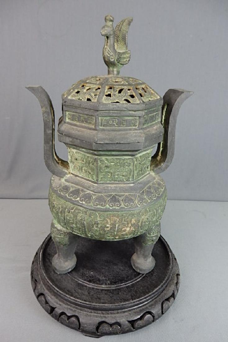 Green Bronze Chinese Incense Burner: Has 3 pieces. The wooden base, lid and burner. With the lid on the whole incense burner (without base) stands 14 inches in height, 7.5 inches wide with a depth of 6.5 inches.