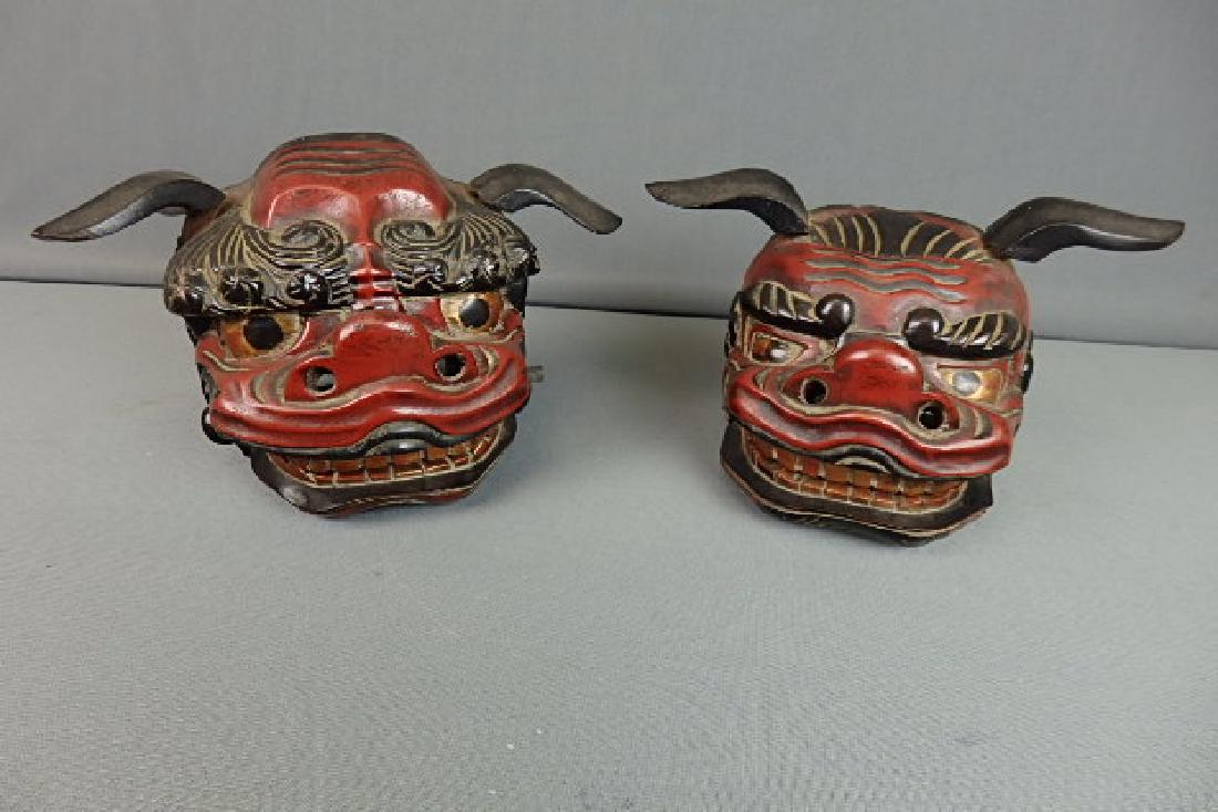 Japanese Pair of Foo Dogs: Both are made out of wood. Not a matching pair. The ears and mouth move on them. 5.5 inches in height, 5 inches in width and a depth of 5 inches.