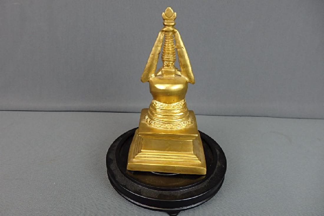 Stupa Buddha Memorial: Made out of brass. There is a tin like tray underneath of it. Very heavy. Comes with wooden base. Just the memorial is 7.5 inches in height width is 3.75 inches and the depth of it is 3.75 inches.