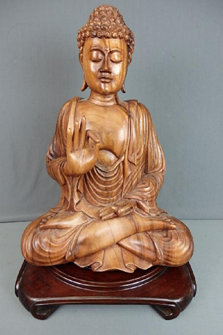 Wooden Buddha with Base: Made out of a solid single piece of wood. Bottom is marked Subrata Bali Novica Collection Indonesia. Comes with a wooden base. The buddha is 17 inches in height, 11.5 inches wide and has a depth of 7 