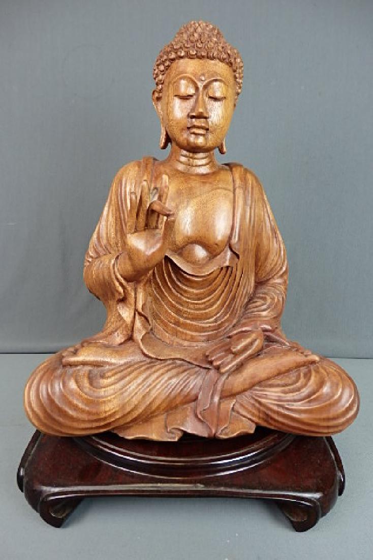 Wooden Buddha with Base: Made out of a solid single piece of wood. Bottom is marked Subrata Bali Novica Collection Indonesia. Comes with a wooden base. The buddha is 17 inches in height, 11.5 inches wide and has a depth of 7 