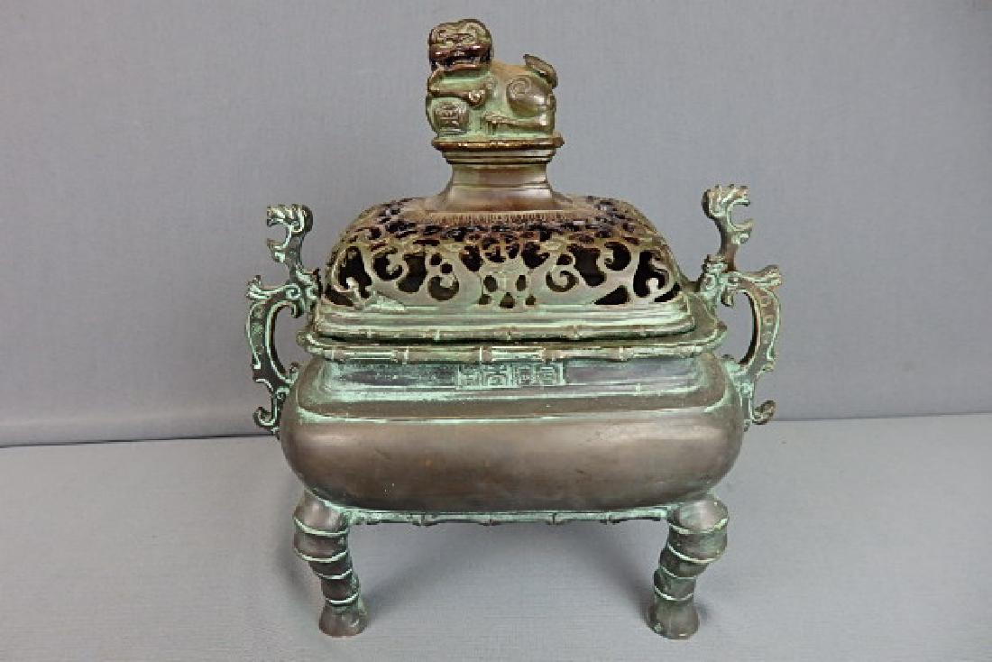 Bronze Incense Burner: Has Chinese characters. With a sticker made in China from the SF Bay Trading Company. Has a Foo dog on the top. Two piece. With the lid on it is 10 inches high, 9 inches wide and 5 inches in depth.