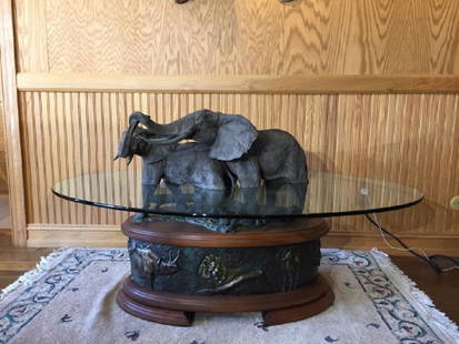 Spectacular Elephant Family Bronze and Glass Table: "Sweet Talk Table", Bronze, glass and walnut wood table, beautiful patina Elephants wading in water, bronze relief base with African animals, 30.5â€™ tall includes elephants x length of