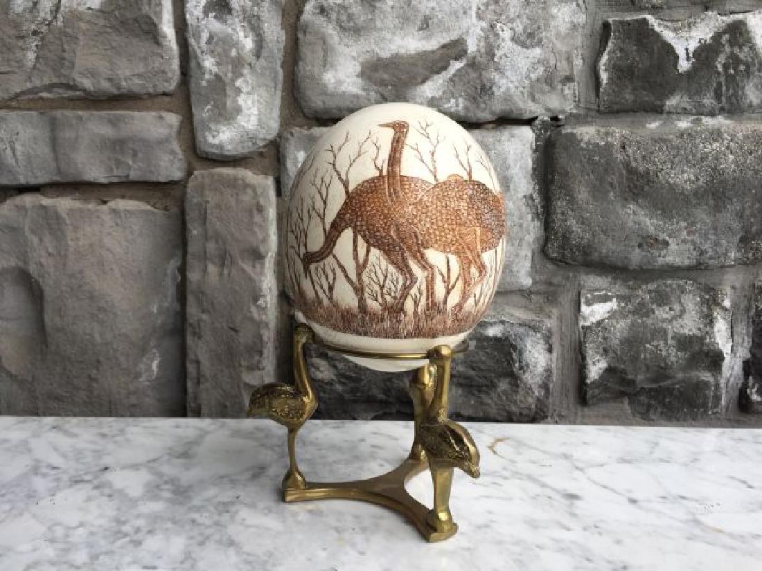 Engraved Ostrich Egg: Engraved Ostrich egg with brass stand, 6.25" egg, signed Sipho