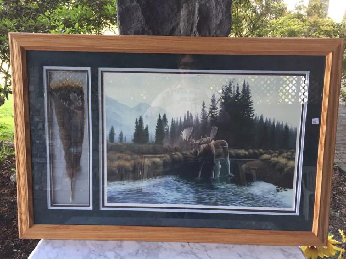 Print of a Moose By Dan Christ: Print of a Moose By Dan Christ with painted feather decoration, 26" x 39" includes frame