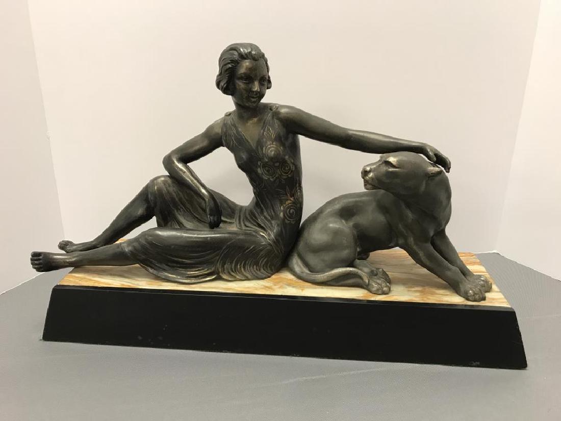 20th century girl and panther sculpture: could not find a maker mark. The Panther and girl are separate pieces. The base feels like it's a plaster or some kind of resin with a marble inlay on it. Size is 18.75 inches long 4.75 inches wide by