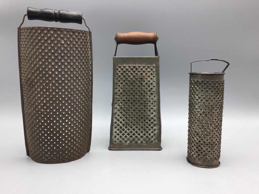 Three large tin ware graters: Largest is 10.5 inches. 2 have wooden handles