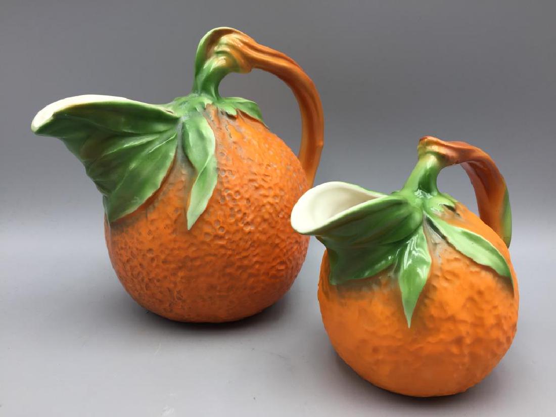 2 Czechoslovakian orange water pitchers: Largest is 8.5 inches tall. Both are marked Czechoslovakia.