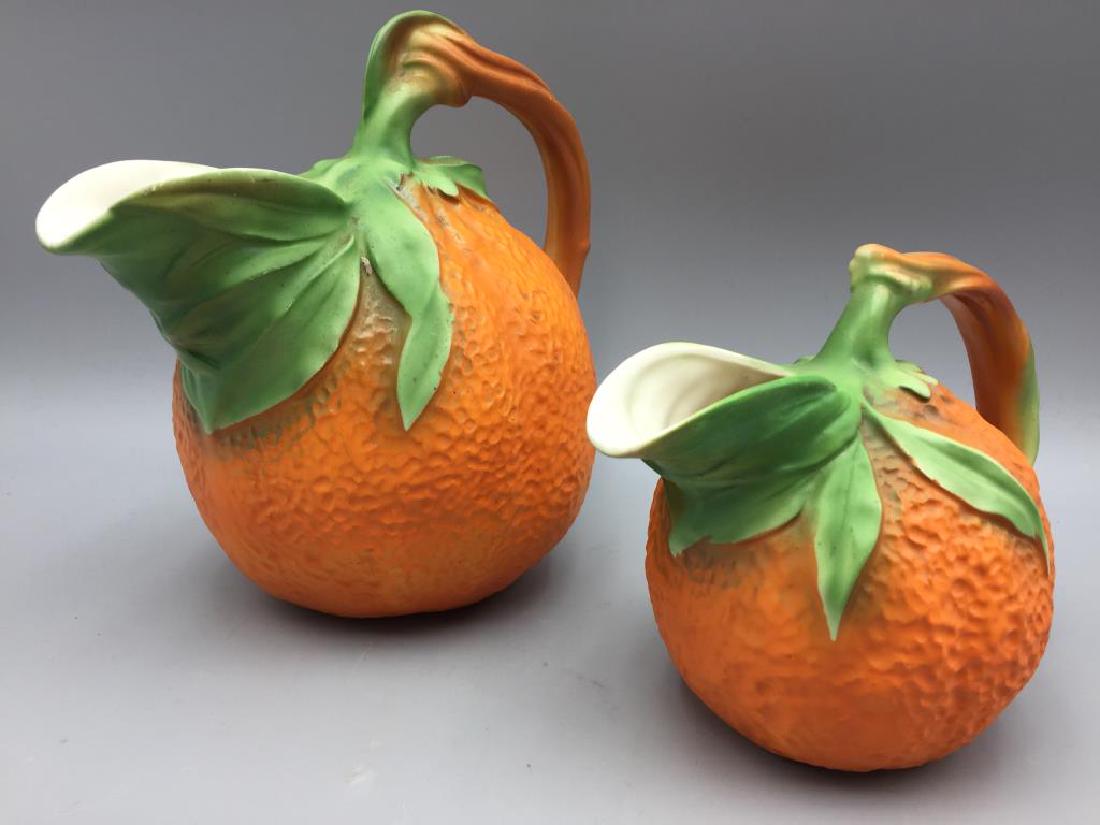 2 Czechoslovakia Orange water pitchers: both are marked on the bottom Czechoslovakia. The largest one is 9 inches tall.