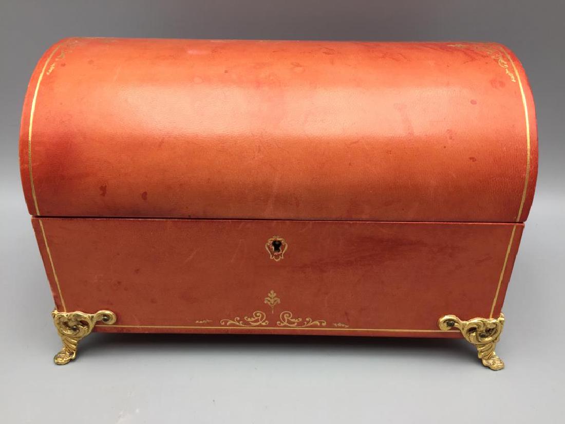 Leather jewelry box: leather dome shaped salmon colored jewelry box. Measures six and three-quarter inches tall by 10 inches long by 6 inches wide.