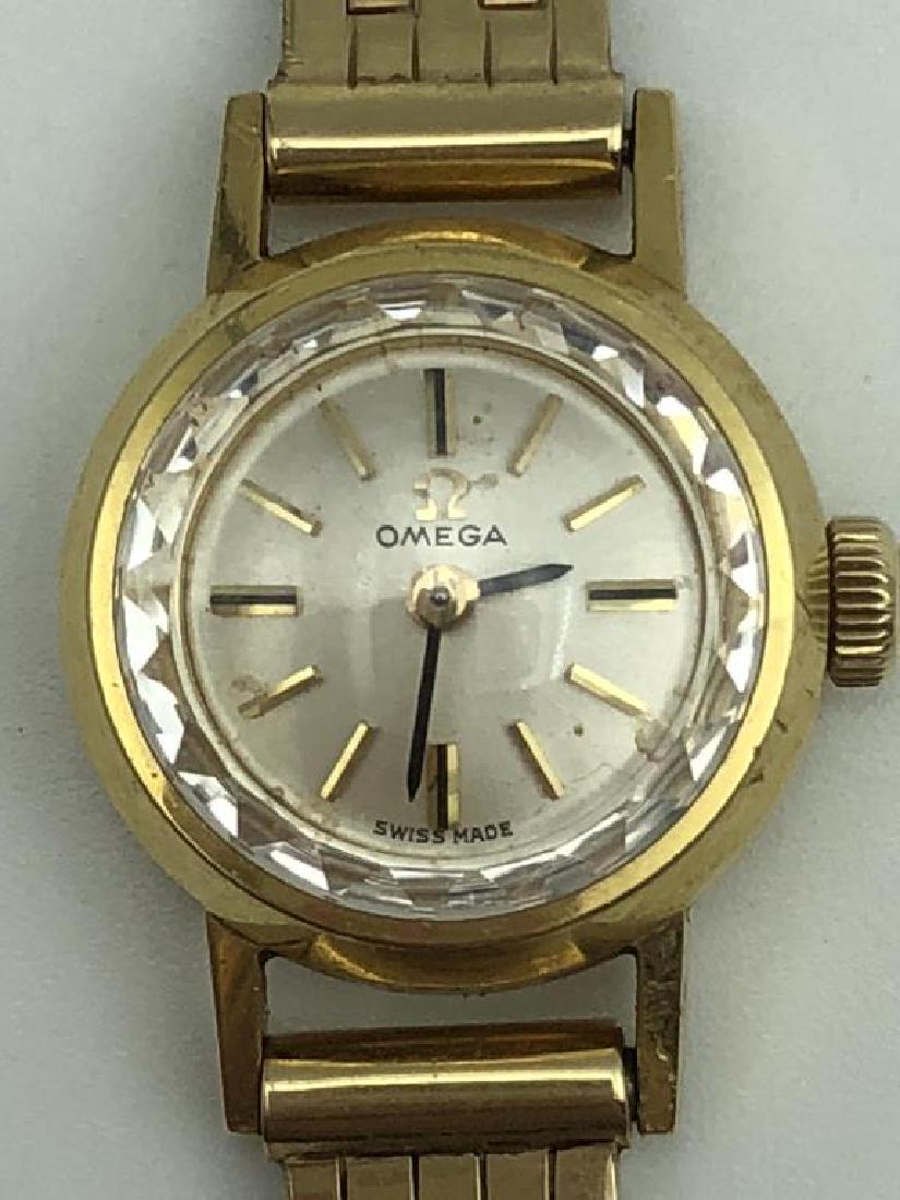 Ladies Omega 14 karat and 18 karat yellow gold: wristwatch; The basket weave band is 14 K, the watch is 18 K, total 14 dwt includes watch works, 6 1/2 inches long, Watch face is .50 diameter, working