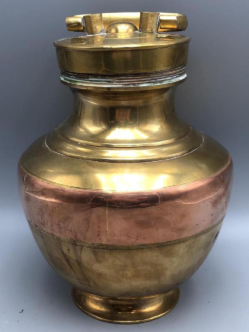 19th Century Brass Wine Flask: Decorated with copper band, top twists off. Initials B.M.W are engraved at the top of the lid, 10 inch height x 8 inch wide.
