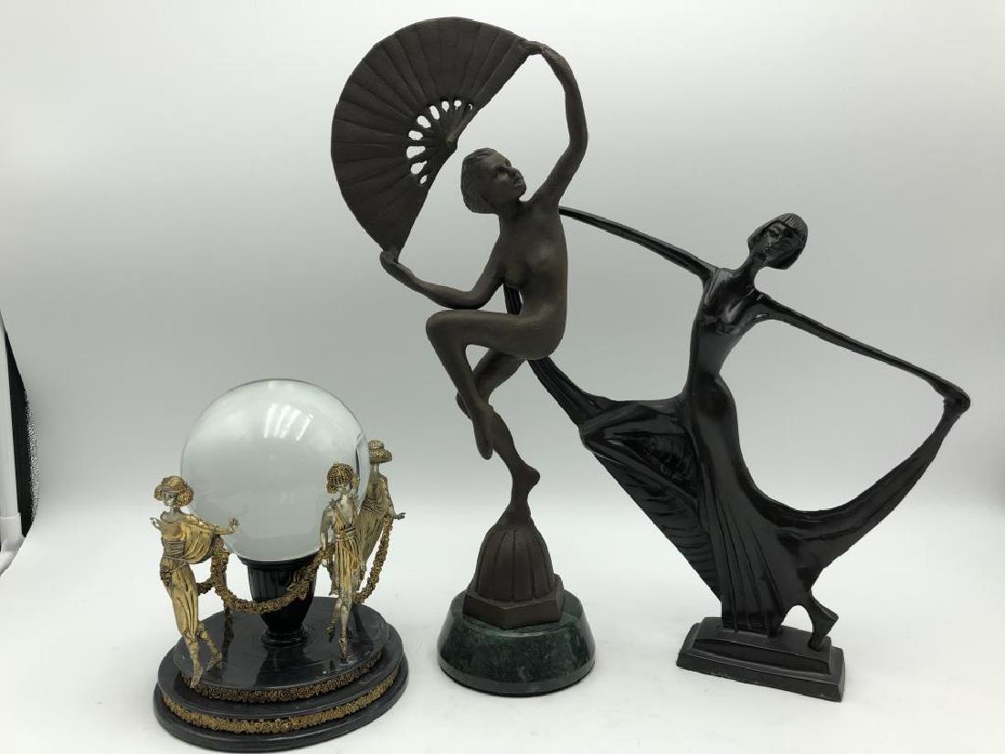 3 Three Art Deco Sculptures: Two metal statues, and "The Erte Crystal Ball Object" by The Franklin Mint, large glass ball in the middle of metal figures. Tallest piece is 14 1/2 inches high by 5 1/2 inches wide.