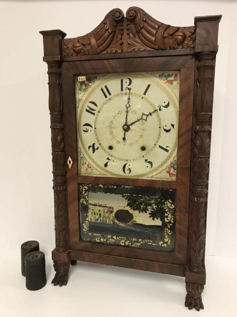 Eli Terry & Sons Mantle Clock: Mahogany pillar and scroll clock with key. Maker label printed inside the clock is torn, shows Eli Terry & Sons made in Plymouth, CT. Decorated with a reverse painted glass of a country estate, some d