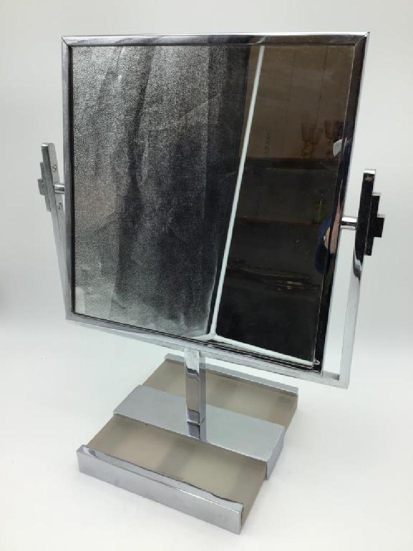 Mid century style vanity/dresser mirror: chrome and frosted acrylic base with swivel mirror, 18 inches tall by 15 inches at the widest point of the mirror.