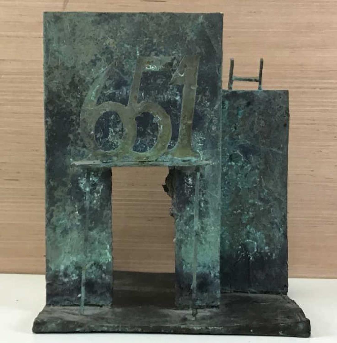 651 Bronze Sculpture by Dennis Leon: Bronze sculpture with architectural qualities of two walls, an entry way and ladder, numbers "651" above the door. Piece is signed and dated by artist on surface, back corner "Leon 64." Measures 13.5 