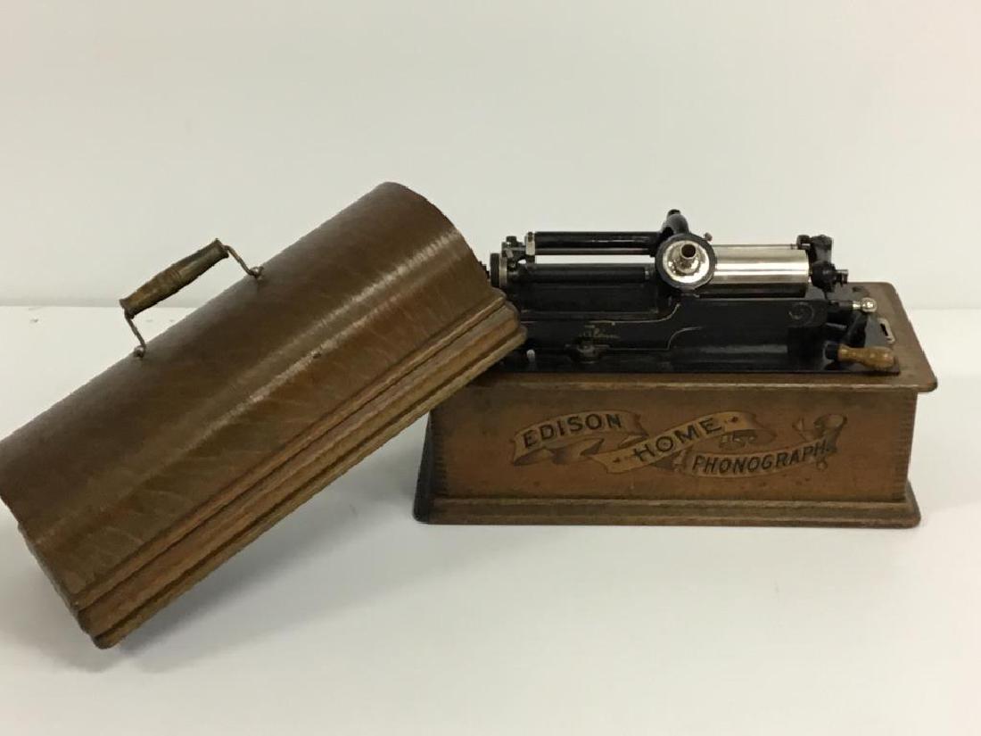 Edison Home Phonograph: As found, needs restoration, 2 and 4 minute machine, circa 1901, Wood case with the name "Edison Home Phonograph" on front in a very nice graphic print. Marked as "MODEL-H 4 MINUTE" hair line scratch 