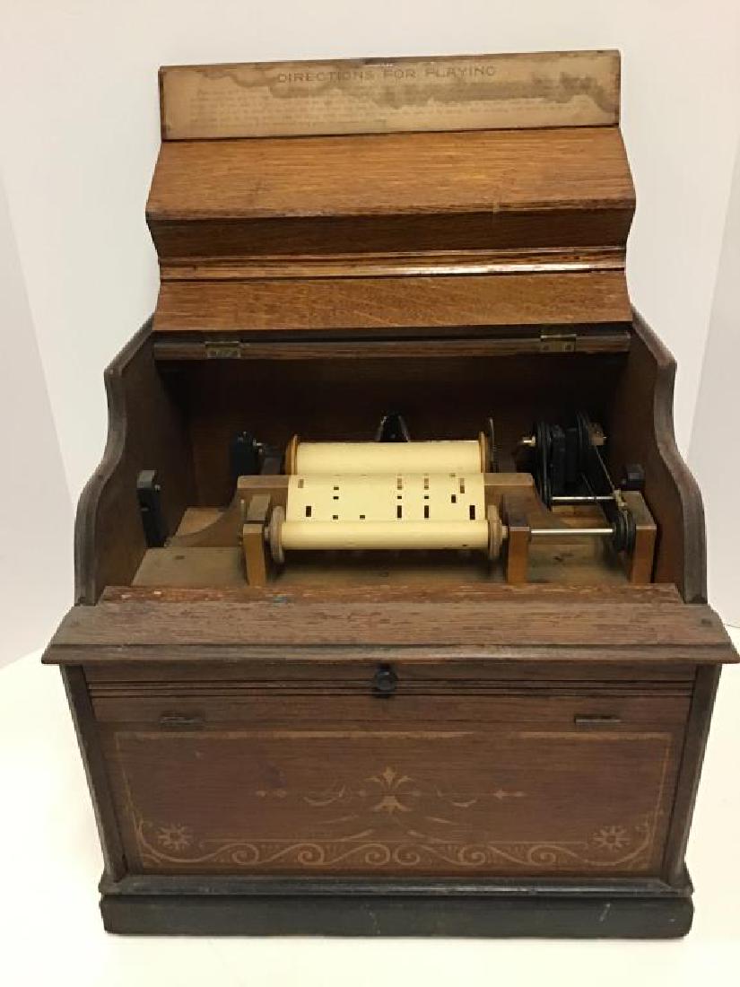 The Improved Celestina Music Box: Roller organ, no crank, Antique wood case needs refinishing,labeled on top of lid, "The Improved Celestina" decorated on all sides with gold paint, top lifts open to printed directions on how to posit