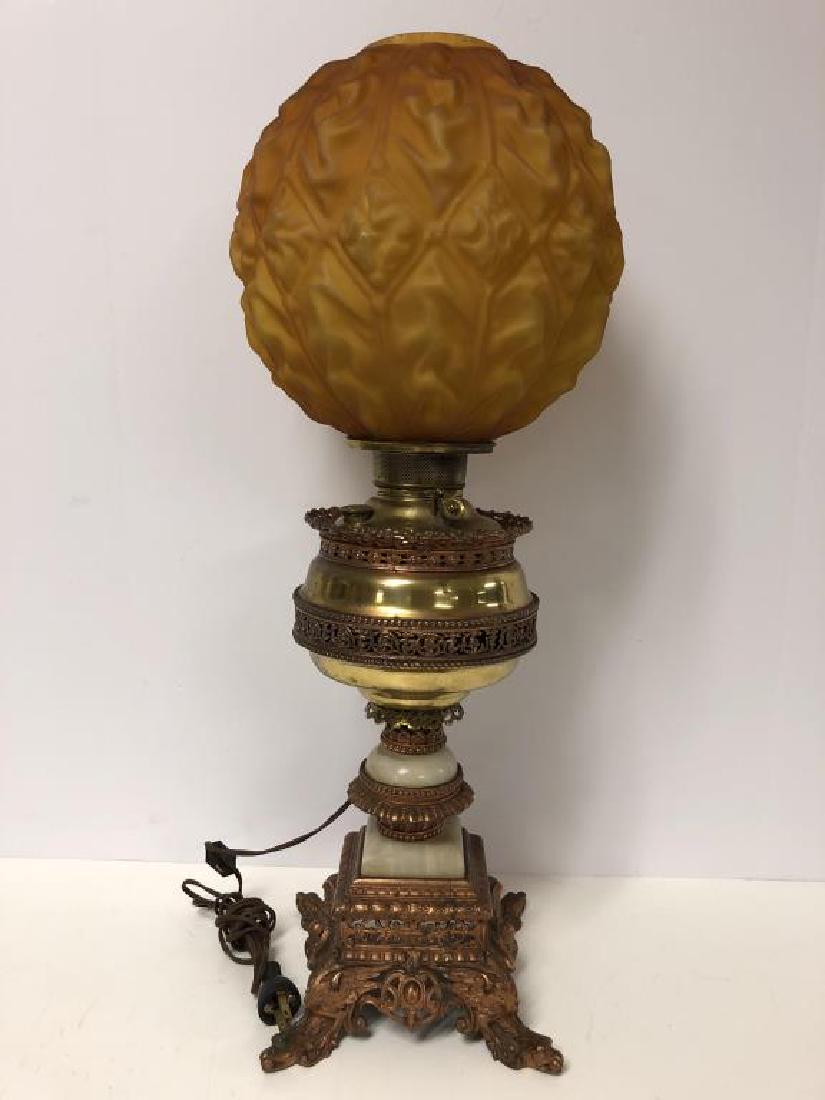 Gone with the Wind banquet lamp: Gone with the Wind banquet table lamp, with amber drape pattern shade, ornate pieced brass and marble base on eagle legs. Shade has a small hole at edge of molding, see photo. Measures 21 inches high,