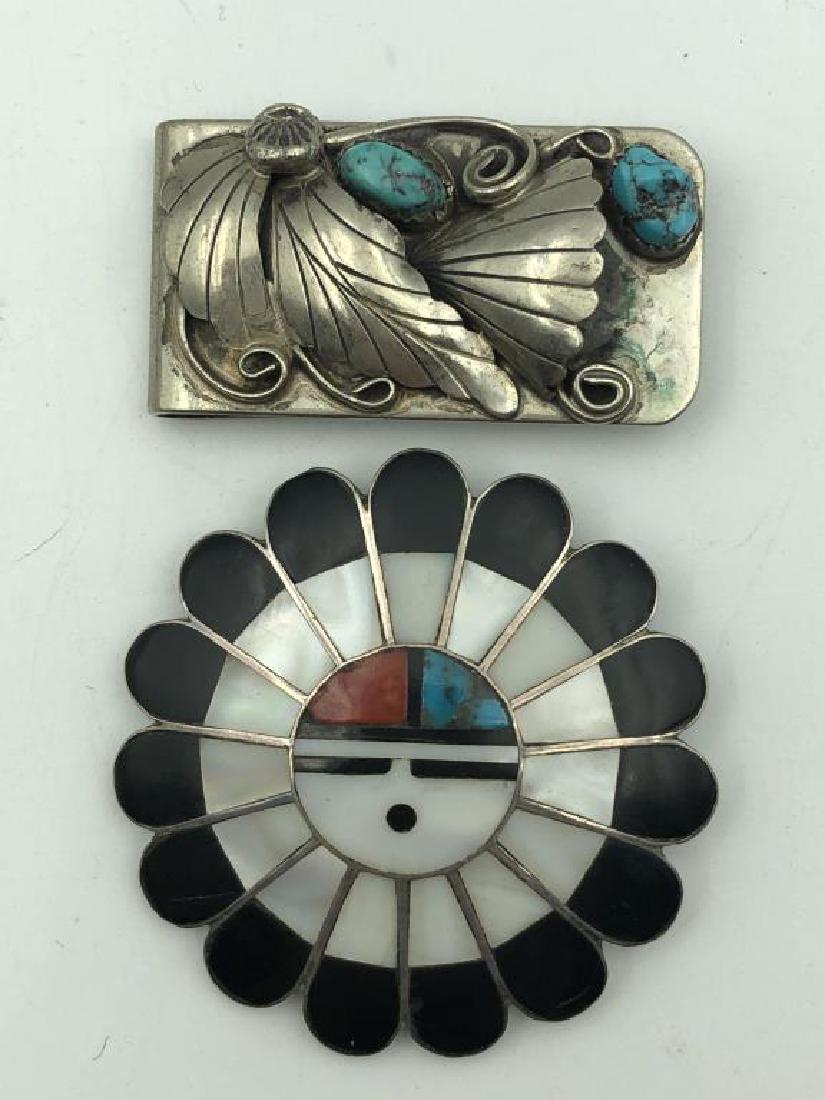 Lot silver money clip and brooch: money clip has 2 turquoise stones, unmarked, inlaid Zuni brooch is 2 inches diameter, engraved E, unmarked