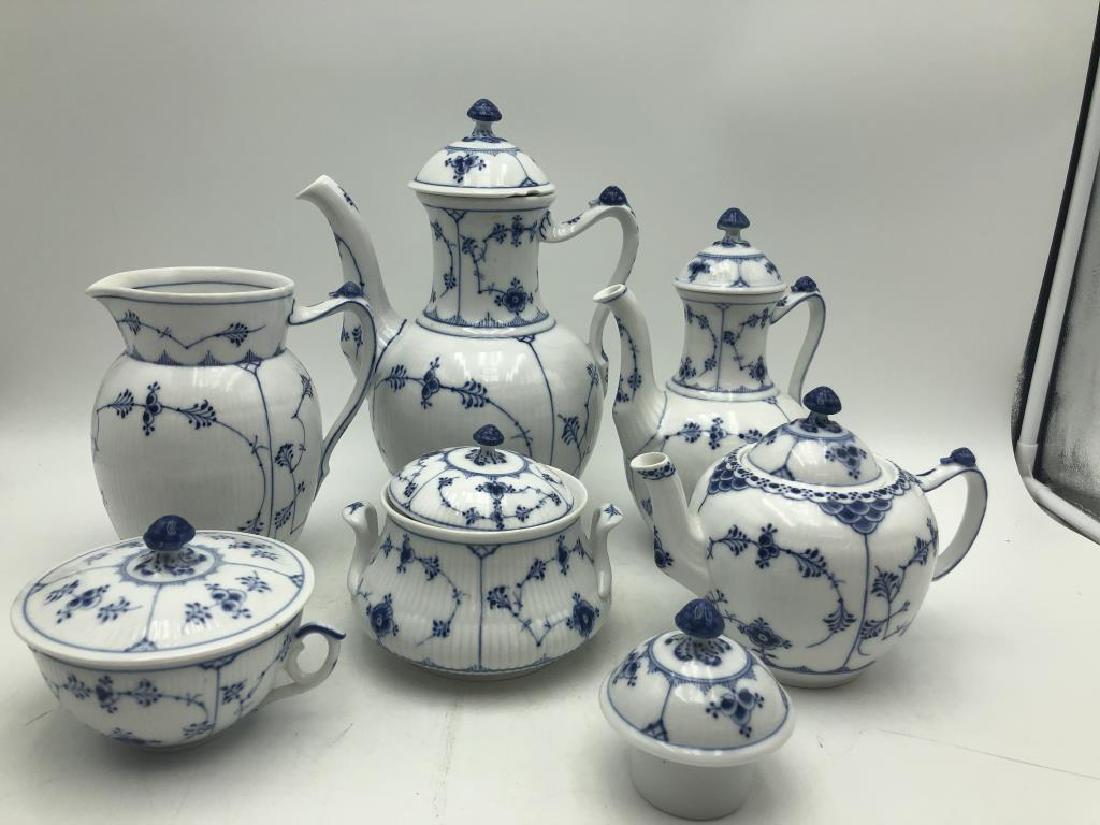 Coffee/Tea Set by Royal Copenhagen: Lot of Royal Copenhagen porcelain tea serving pieces in Blue Fluted Full Lace pattern. Maker mark and numbers on bottom of each. Includes three tea pots with lids, a fourth lid, a cream jug and two co