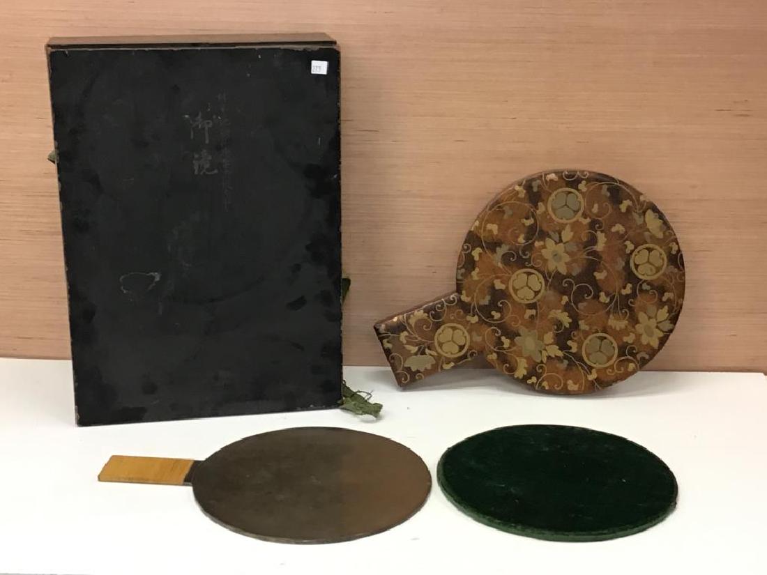 Ornate Japanese Mirror: Japanese hand mirror, heavily decorated and ornate storage case. Metal face has traditional images on one side, reflection shown on flat metal side. Mirror is in protective velvet slip, stored in cust