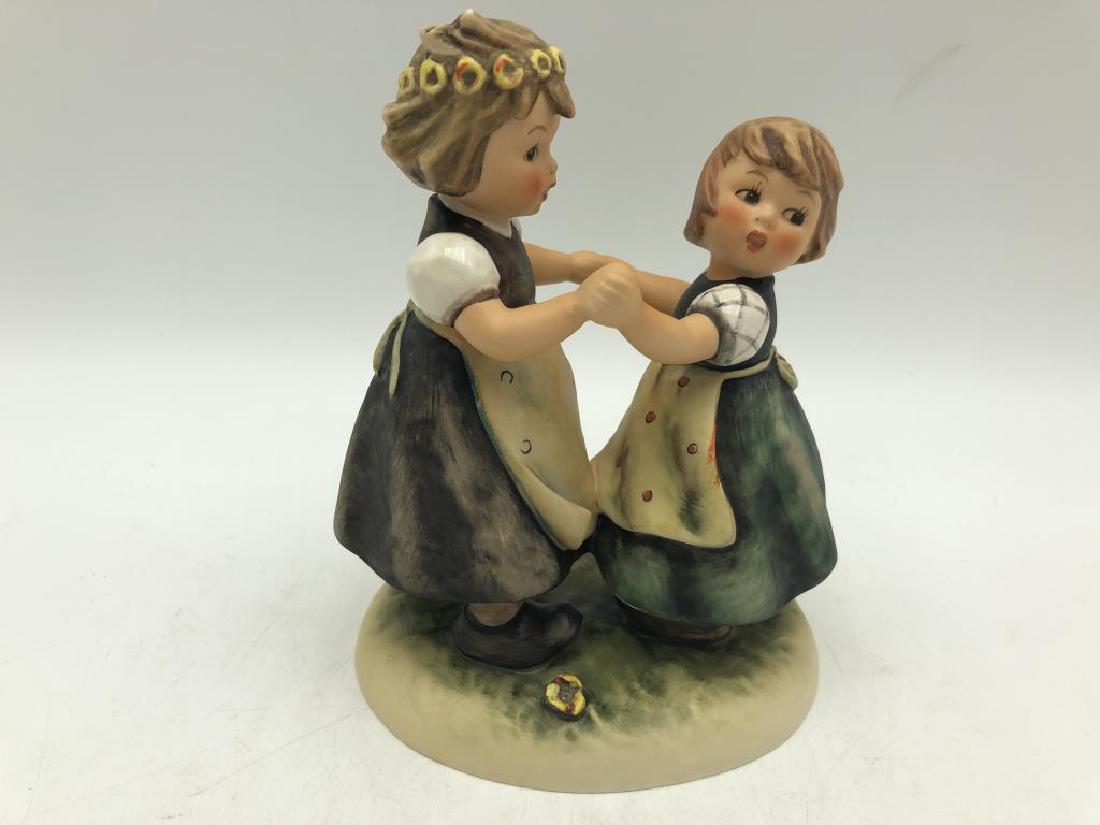 Girls dancing Hummel Figure: Hummel figure featuring two girls dancing, Hummel signature on base, maker mark on bottom, "Goebel W. Germany" and "353/I, N., 95", good condition. Measures about 7 inches high by 5 inches wide by 4 i