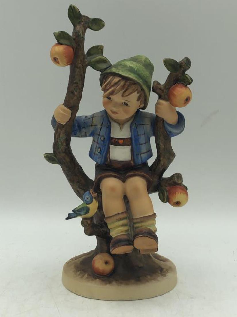 "Apple Tree Boy" Hummel Figure: Hummel figure featuring young boy in apple tree, M.J. Hummel signature on base, maker mark on bottom, "by W. Goebel W. Germany" numbered 142/V, dated 1968, good condition. Measures about 10.5 inches h