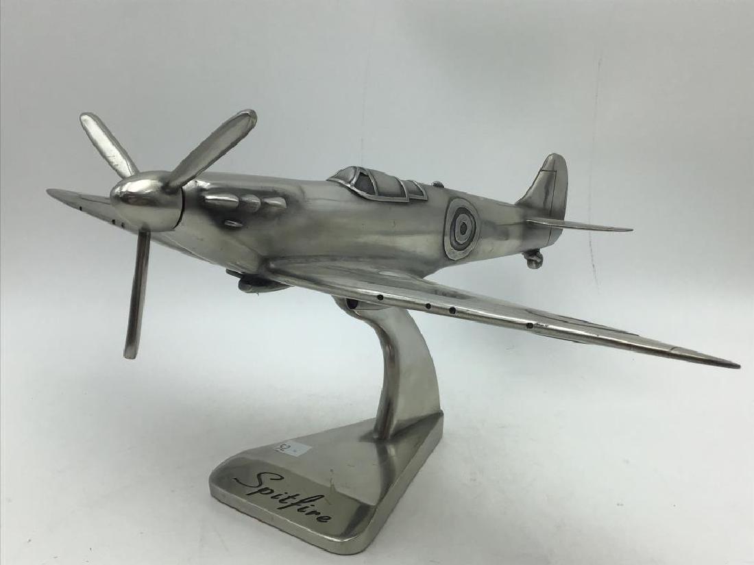 Spitfire Airplane: Cast white metal Spitfire airplane, no makers mark. Wingspan is 20 inches wide. Provenance: From the Estate of Raymond Bentley.