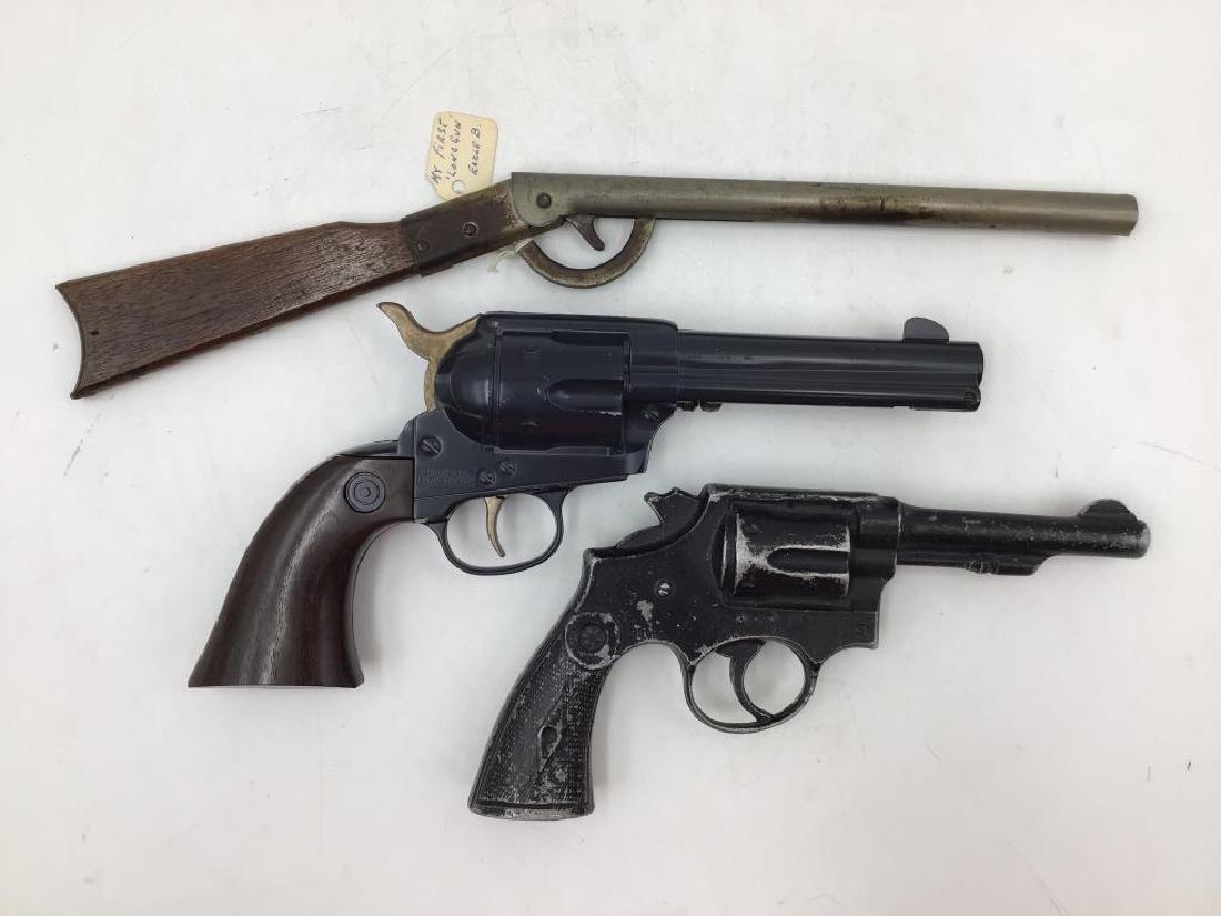 Lot of 3 miscellaneous toy guns: Daisy cork gun, Daisy 6 shooter pistol (cylinder is stationary), dummy revolver prop. Provenance: from the Estate of Raymond Bentley