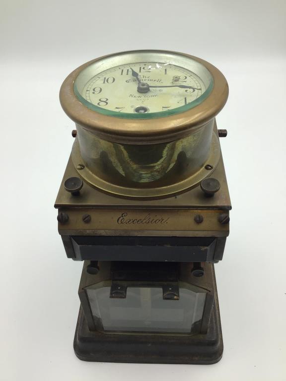 Gamewell Excelsior Time Stamp Clock: Clock face marked by the Gamewell Co. of NY, Excelsior engraved on front of brass case. Measures approximately 11 inches high by 6 inches wide by 7 inches deep. From the Raymond Bentley Estate.