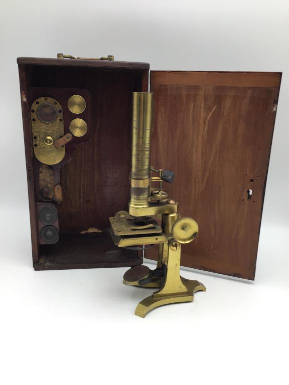 Brass Microscope in Wood case: Wood case includes microscope and is custom built to fit additional tools and lenses, case is about 6.5" high by 14" wide by 8" deep. From the Estate of Raymond Bentley.