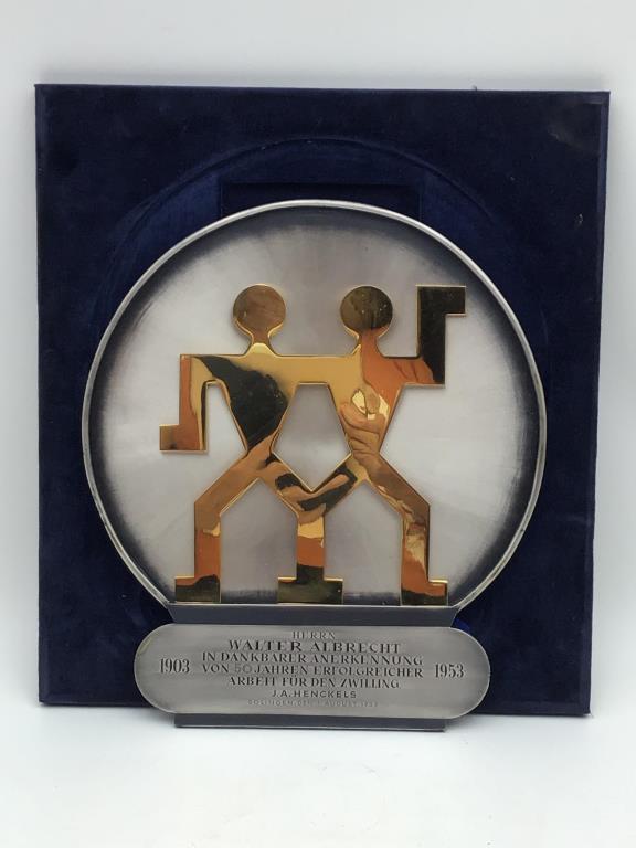 1953 German Employee Plaque: Employee recognition award from 1953 for Mr. Walter Albrecht by Zwilling J. A. Henckels, knife manufacturer based in Solingen, Germany. Engraved pewter with brass company logo mounted on blue velvet.