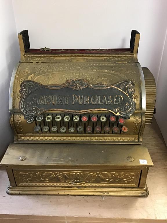 National Cash Register #818: National cash register, numbered at top center 914647, 818, Brass and wood, Top sign needs to be reattached, front door is locked without key. Black film on surface. No glass cover over number plates.