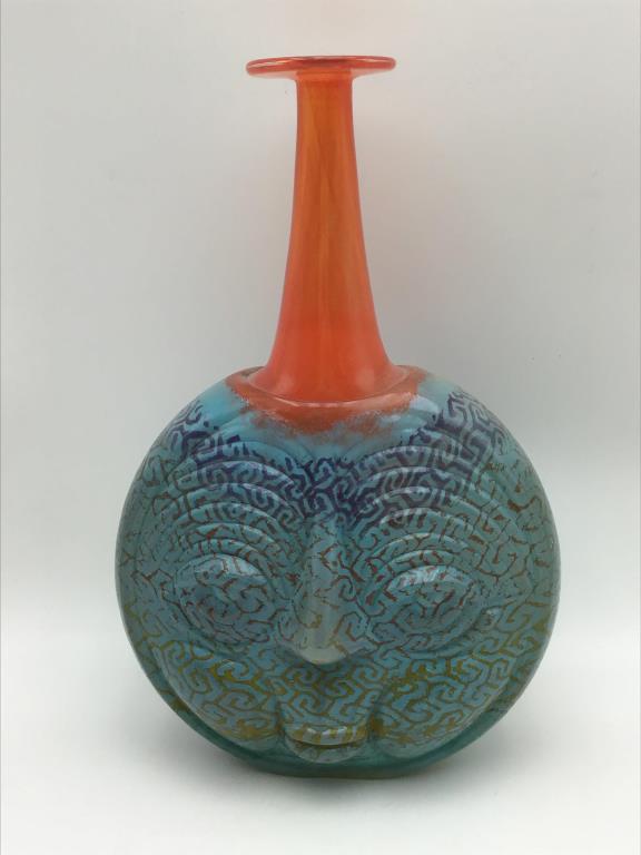 Signed Kosta Boda Art Glass Vase: Kosta Boda name on lower back of the Art Glass vase decorated with blue and orange pattern and face on front side. Signed on bottom by current glass artist for Kosta Boda, Kjell Engman, and numbered 1
