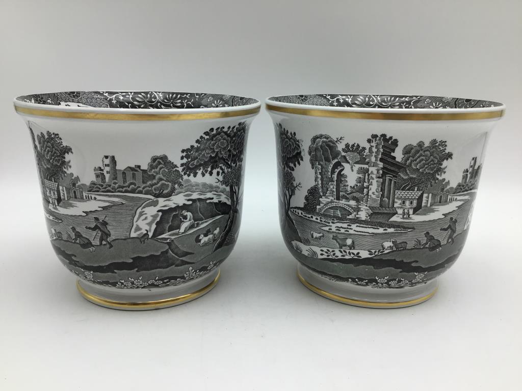 Pair Spode Planters: Pair of black on white image porcelain planters, gold trim, marked on bottom by Spode England, one is numbered, see photos. Good/used condition. Measure about 5.75" high by 7" diameter across top.