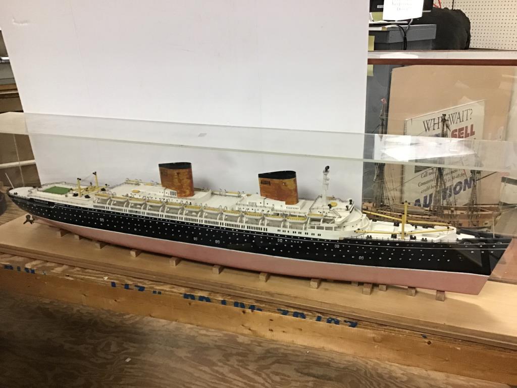 Model Ocean Liner: Model of an Ocean Liner in plexiglass case. All windows and details are hand painted, good condition. Measures about 16.5" high by 68" wide by 10.5" deep. From the Estate of Raymond Bentley.