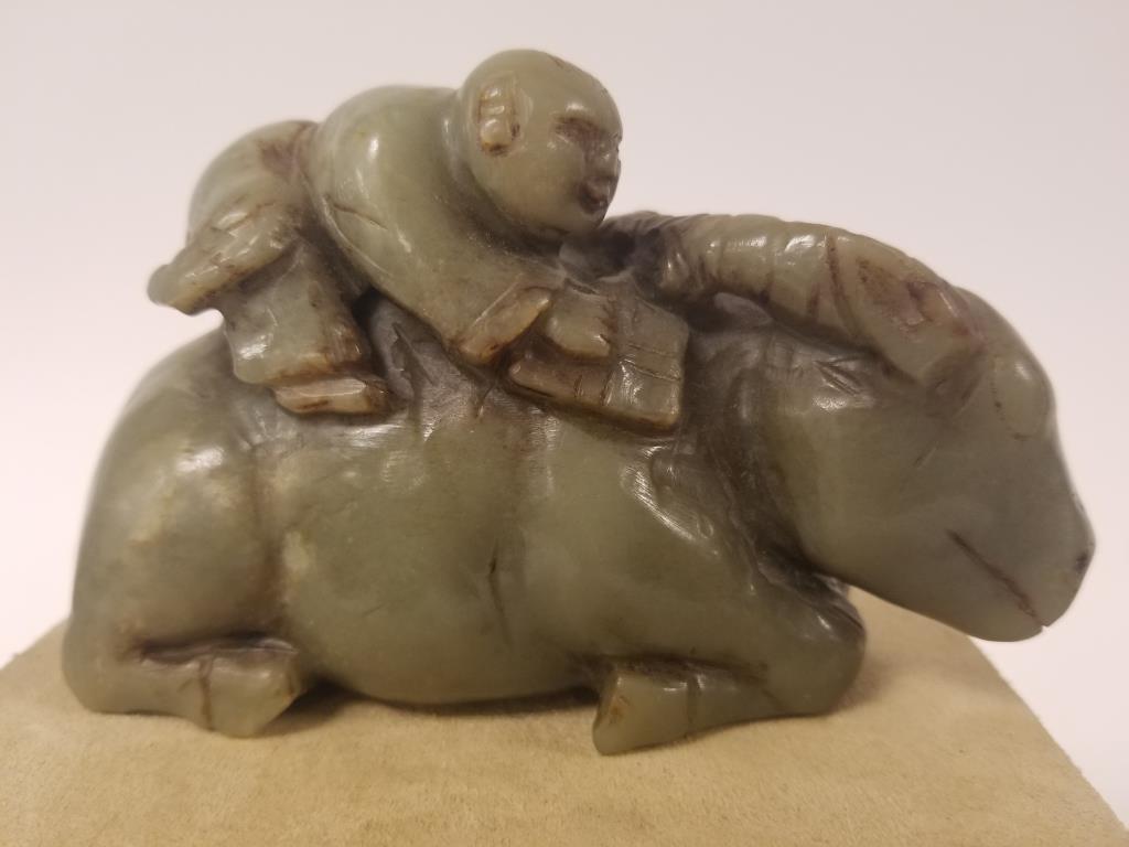 Carved Jade Asian man seated upon reclining bull: figure Measures 5" x 3" x 2"