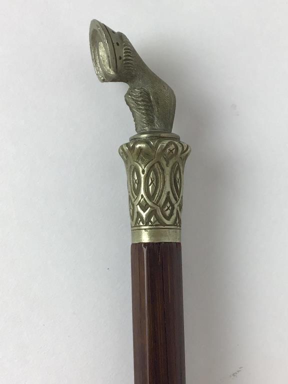 Late 19th Century horse arena stick: Typically used by auctioneers to lead horses around the ring, wooden arena stick 38 1/2 inches long, includes a 2 1/2 inch detailed metal horse hoof handle
