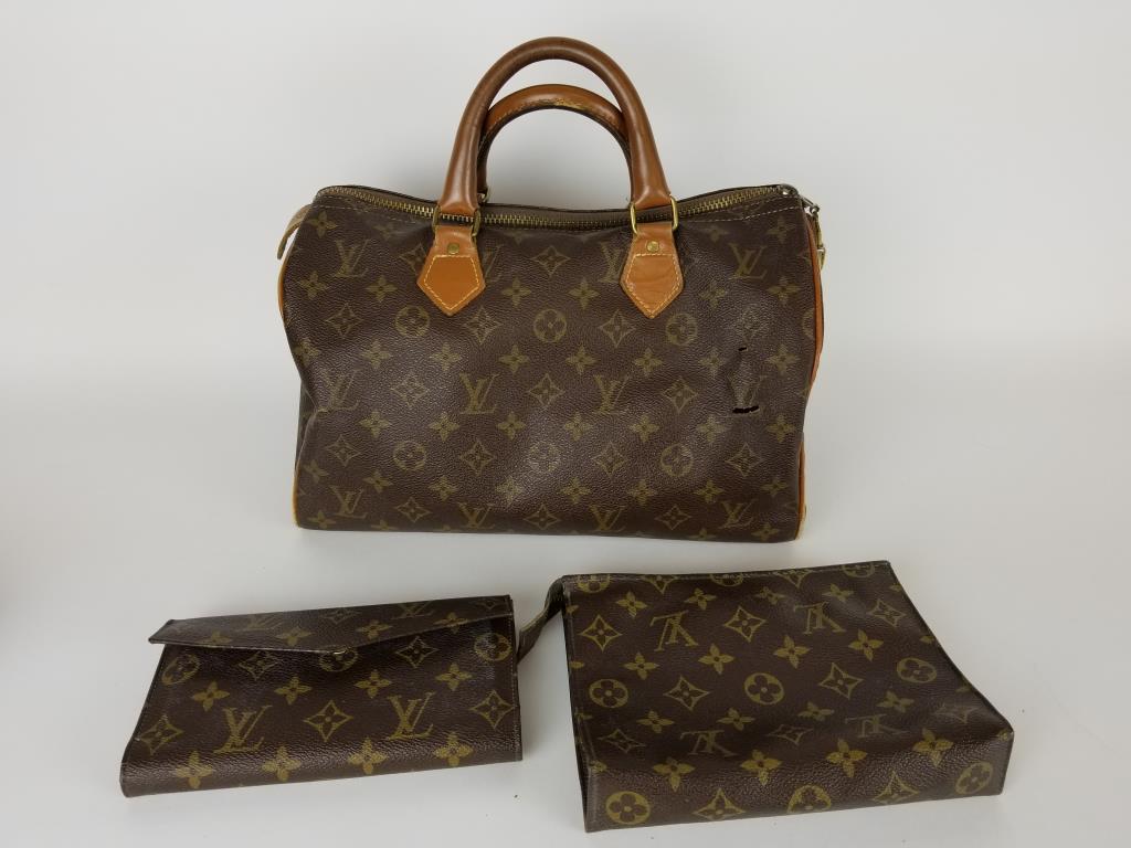 Louis Vuitton Speedy handbag set: Louis Vuitton Speedy handbag, wallet and make up bag. No key for the lock, and there are several small holes in the Speedy. Bag measures 12 inches wide x 8 inches tall x 7 inches deep. Wallet snap doe