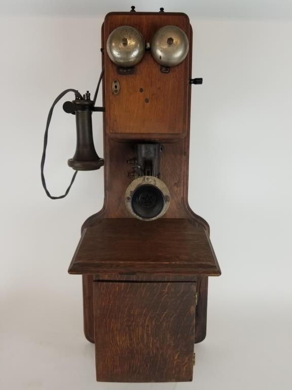 Antique wooden wall telephone: antique wall phone, with hand crank and hidden rotary dialer. Measures 30 inches tall.