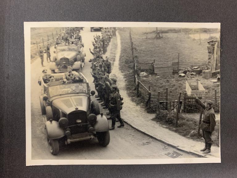 1939-1940 Fall of France photo album: Fabric covered photo album, filled with early WWII German military photos, Panzer, crashed British or French airplanes, destroyed villages, ambulance related photos, prisoners of war walking, high ran