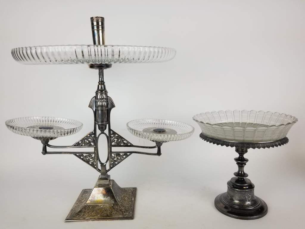 2 vintage silverplate and glass pedestal servers: Reed and Barton single pedestal server with Native American hunt scene on the pedestal with frosted glass insert. Unmarked triple pedestal server, it measures 17 inches tall.